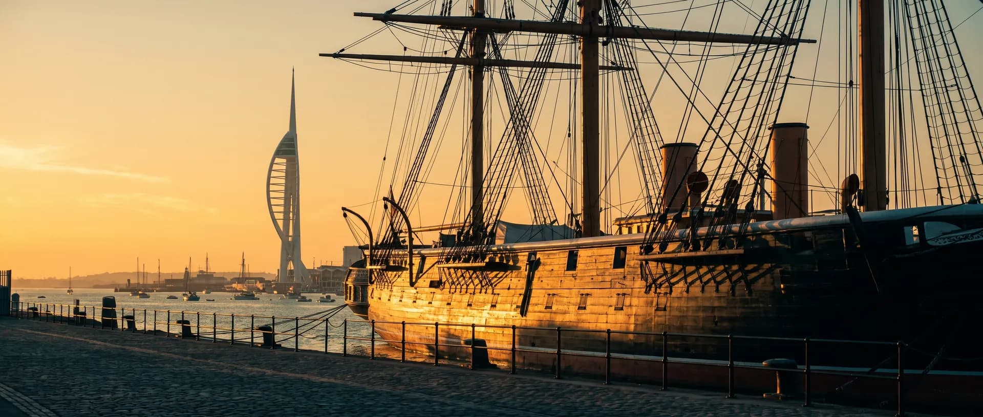 Portsmouth Historic Dockyard at golden hour with HMS Warrior, near Basing, Hampshire